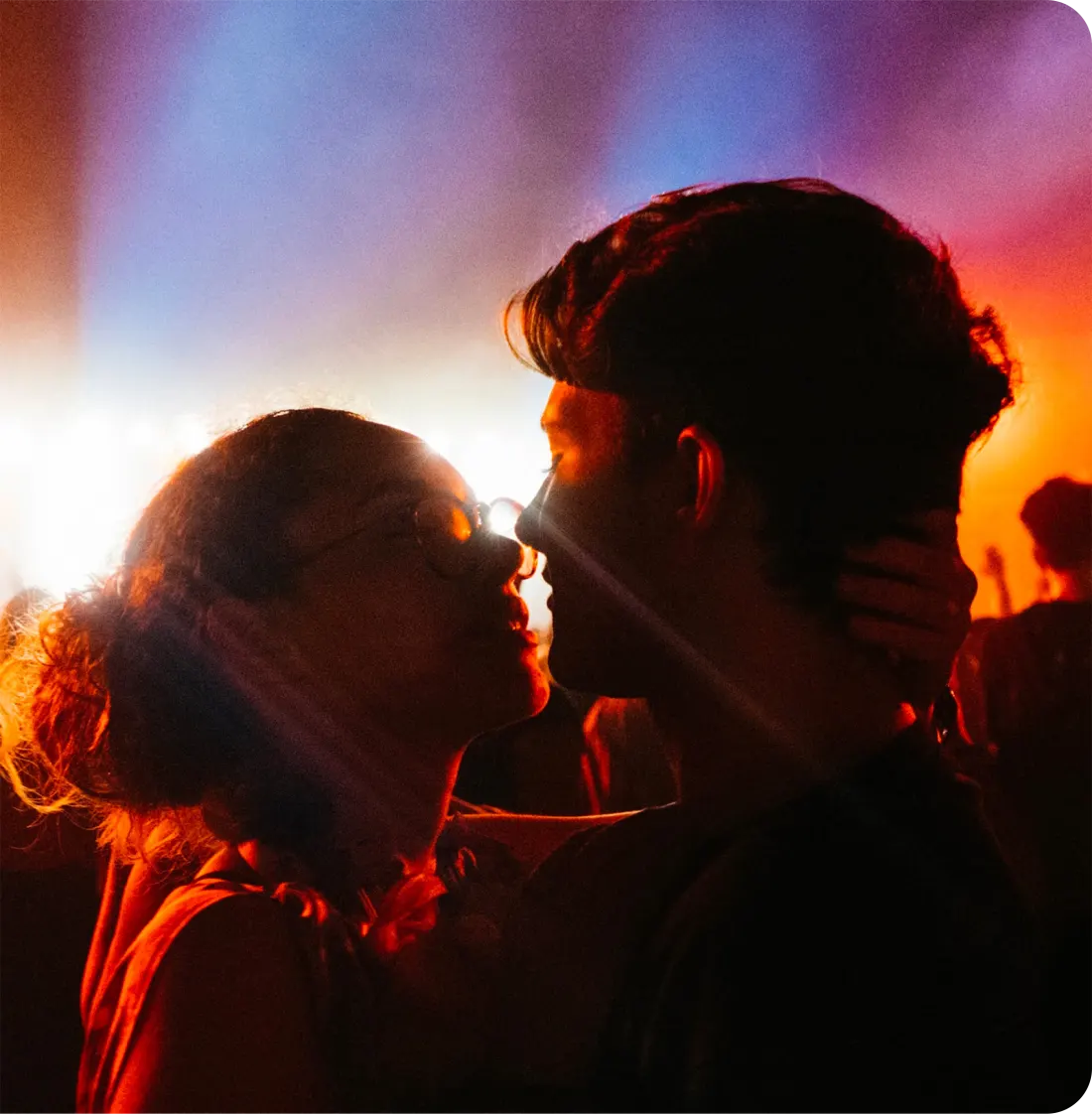 A couple kissing at a concert